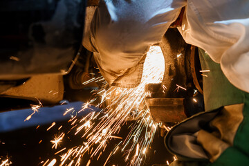 Sparks Flying During Metal Cutting in Automotive Workshop