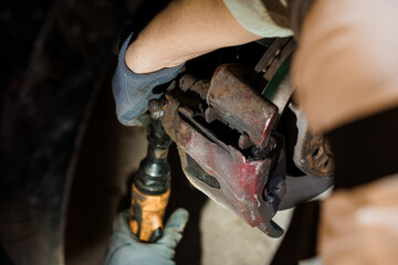 Detailed Close-up of an Auto Mechanic Repairing a Brake System