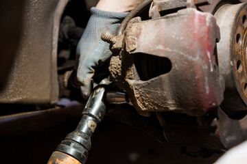 Close-Up of Automotive Brake Caliper Repair with Socket Tool