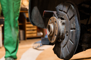 Detailed Close-Up of a Car Brake System in a Workshop Setting