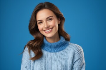 Fototapeta premium arafed woman in a blue sweater smiling and looking at the camera
