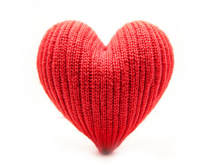 Knitted heart made of red wool threads. light white background.