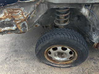 flat tire accident in car park on the street waiting for repair. flat tire and spare concept. copy space