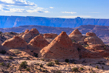 A mountain range with a few red rock formations