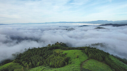 Aerial landscape view of the sea of fog flowing on hills by drone