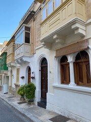 A side view of Triq Gùze Cardona in Sliema showcased the classic Maltese architecture, with typical balconies hanging above the street. Below, unique wooden doors. January 5, 2022