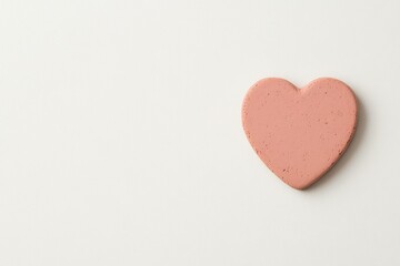 Soft pink heart on a minimalistic background, symbolizing love, affection, and romance in a modern, clean design perfect for seasonal themes