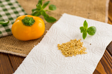 yellow pepper seeds on wooden table