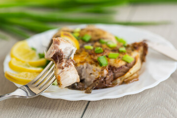 Fish with herbs and lemon on a plate