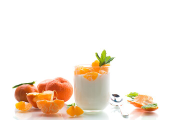 Refreshing dessert with tangerines and yogurt, isolated on white background