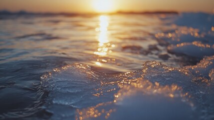 Icy ocean close up at sunset with drifting ice and shimmering water reflections providing ample space for text or overlay design