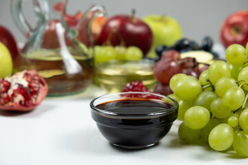Balsamic vinegar on the background of fruits and other types of vinegars.