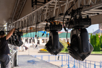 Installation of lighting equipment on a mobile concert stage.