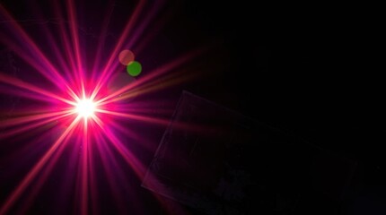Obraz premium Vibrant Light Burst with Color Flares Against Dark Background