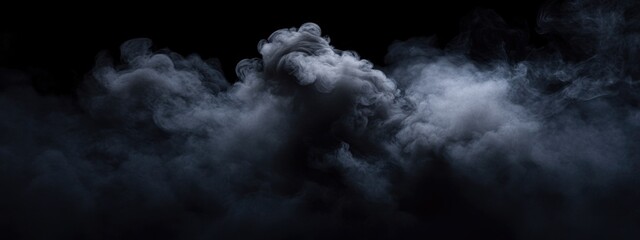 Fototapeta premium Dramatic black clouds in the sky creating a mysterious moody atmosphere with space for text or design elements in a dark background