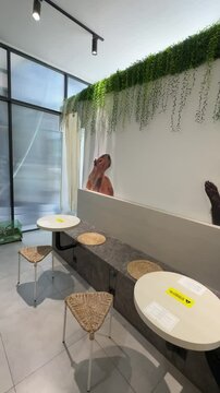 minimalist, white and modern interior design of an animal themed cafe, capybara cafe at Fox Cafe, BSD area. pet cafe, animal printed board, cafe decorations