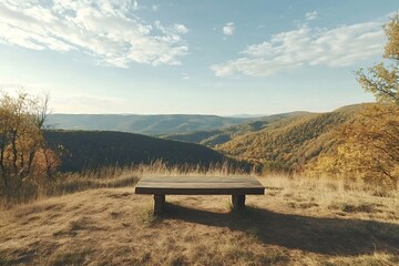 Wooden bench placed on a hilltop offers breathtaking views of rolling hills covered in colorful autumn foliage under a cloudy sky as the sun sets, creating a tranquil and inviting scene