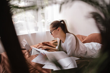 Accountant working on financial report in bedroom