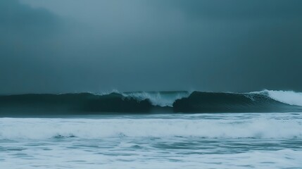 Naklejka premium Misty Coastal Landscape with Rolling Waves