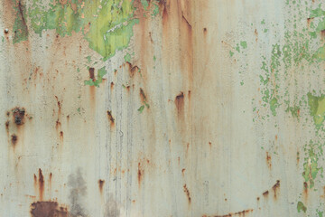 Old rusty metal surface with peeling paint and dirty streaks from rain. Cracked paint texture. Background, texture. Corrosion of iron with streaks of rust. Peeling paint on rusty and old metal