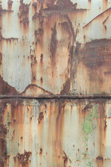 Old rusty metal surface with peeling paint and dirty streaks from rain. Cracked paint texture. Background, texture. Corrosion of iron with streaks of rust. Peeling paint on rusty and old metal