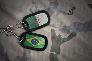vintage army blank, dog tag with flag of algeria and brazil on the khaki texture background....