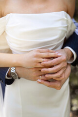 Fototapeta premium hands of newlyweds in the arms of the bride with wedding rings