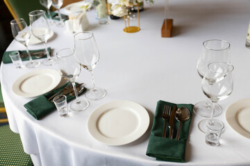 decorated round table with tablecloth in restaurant at banquet	
