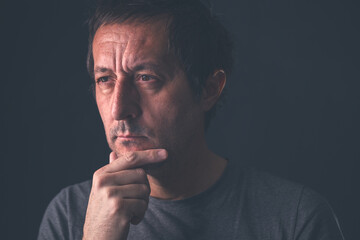 Bemused man, preoccupied and deeply absorbed in thoughts