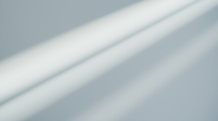 Soft beams of light cascade across a textured wall, creating an ethereal atmosphere in a serene indoor space