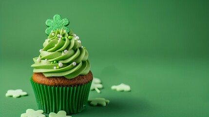 Decorated cupcake on green background