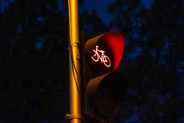 bicycle traffic light signaling red light, at night
