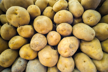 pile of unpeeled fresh potatoes, closeup