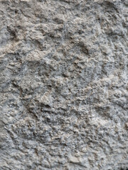 Obraz premium A roughly hewn stone block stands on a smooth gabbro stone pavement, which could be a counter in an office or hotel