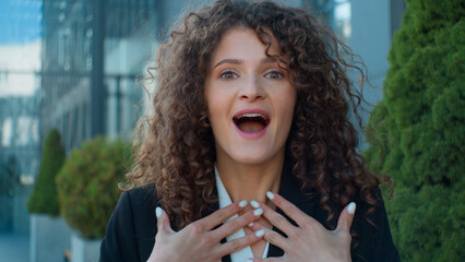 Outdoors business portrait Caucasian amazed shocked young girl woman looking at camera open mouth...