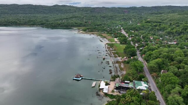 Lake Peten Itza in Guatemala, with a thatched hut perched on a platform extending over calm
