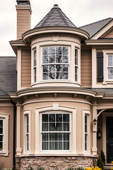 Obraz premium Elegant Home Exterior with Bay Window and Stone Facade. Classic Architecture, Luxury Real Estate, Modern Design, Residential Property