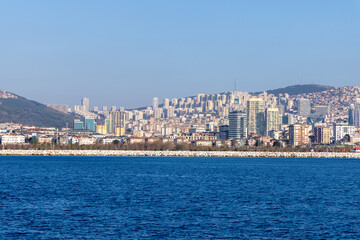 Skyline of Istanbul’s Asian side with modern residential buildings and a rocky shoreline. A vibrant view of the Anatolian side blending urban development and coastal beauty. Panaromic Istanbul 2025