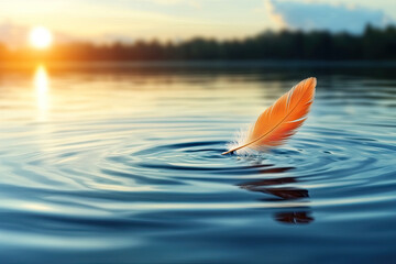 A vivid orange feather floats on calm water, creating gentle ripples, with a serene sunset backdrop enhancing the tranquil scene.