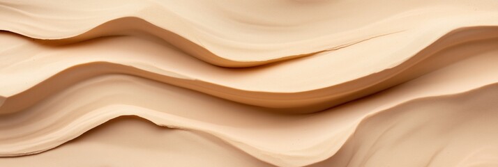 Obraz premium A sandy beach with a wave pattern. The sand is light brown and the waves are curved. Concept of relaxation and tranquility, as the viewer can imagine themselves lying on the beach