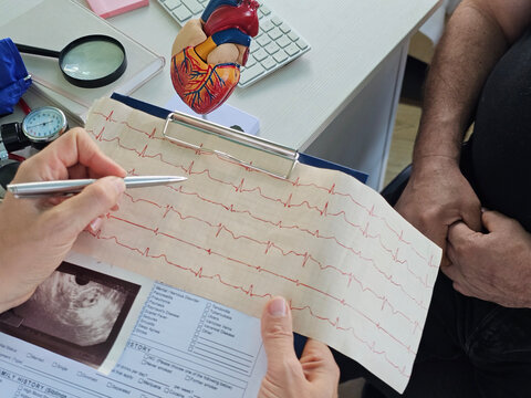 Doctors at the table talk about the patient analysis, a close-up. Diagnosis of the disease