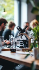 Microscope focus with scientists in the background