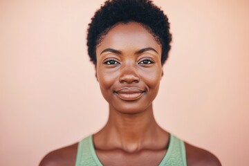Confident Young Black Woman Smiling Against a Peach Background