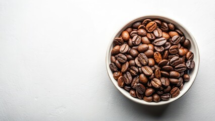 Fototapeta premium Freshly roasted coffee beans in a bowl with a minimalist white background, highlighting the texture and color of the coffee grounds , white background, kitchen