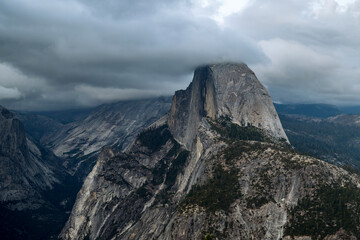 Sunset on Half Dome, as seen from Glacier Point. The tip of half dome is shrouded in cloud
