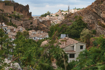 Scenic medieval townscape surrounded by hills and lush greenery