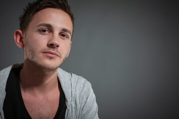 Obraz premium Male Model. A series of casual poses by a male model in the photo studio sets against a neutral backdrop.