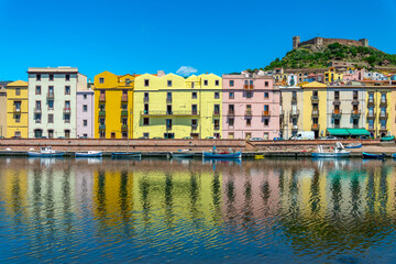 View of colorful houses with water reflections in the Temo river in the old town of Bosa, Sardinia...