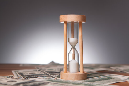 hourglass and hourglass on wooden background. time management concept. - Powered by Adobe