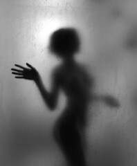 Black and white woman silhouette. Beautiful woman taking a shower. 